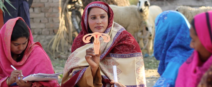 Pathfinder-Pakistan-Lady-Health-Worker-with-uterine-model-in-field-inspire