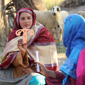 Pathfinder - Pakistan Lady Health Worker with uterine model in field