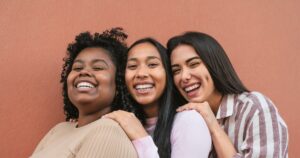 Three women smiling